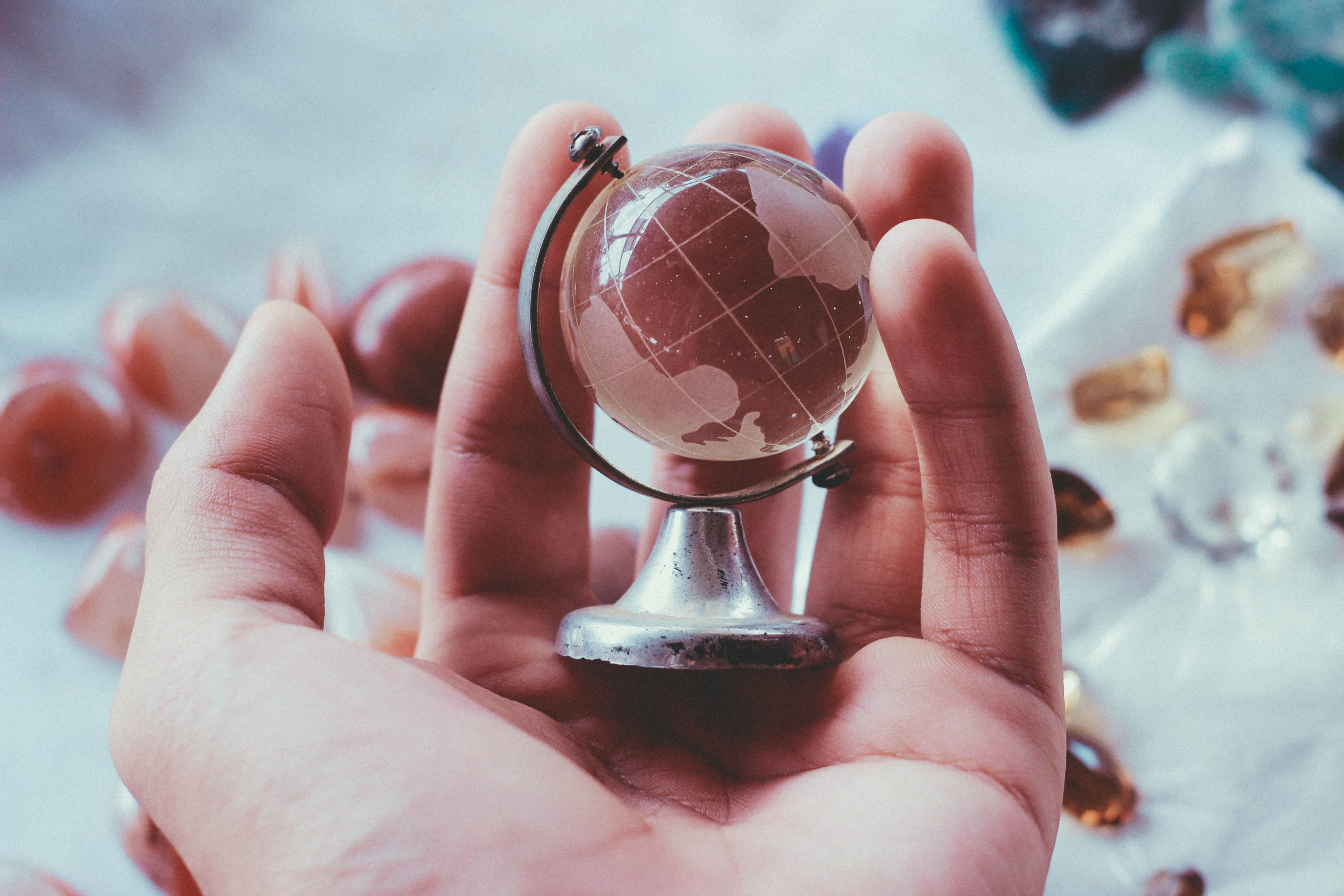 hand holding a miniture glass globe