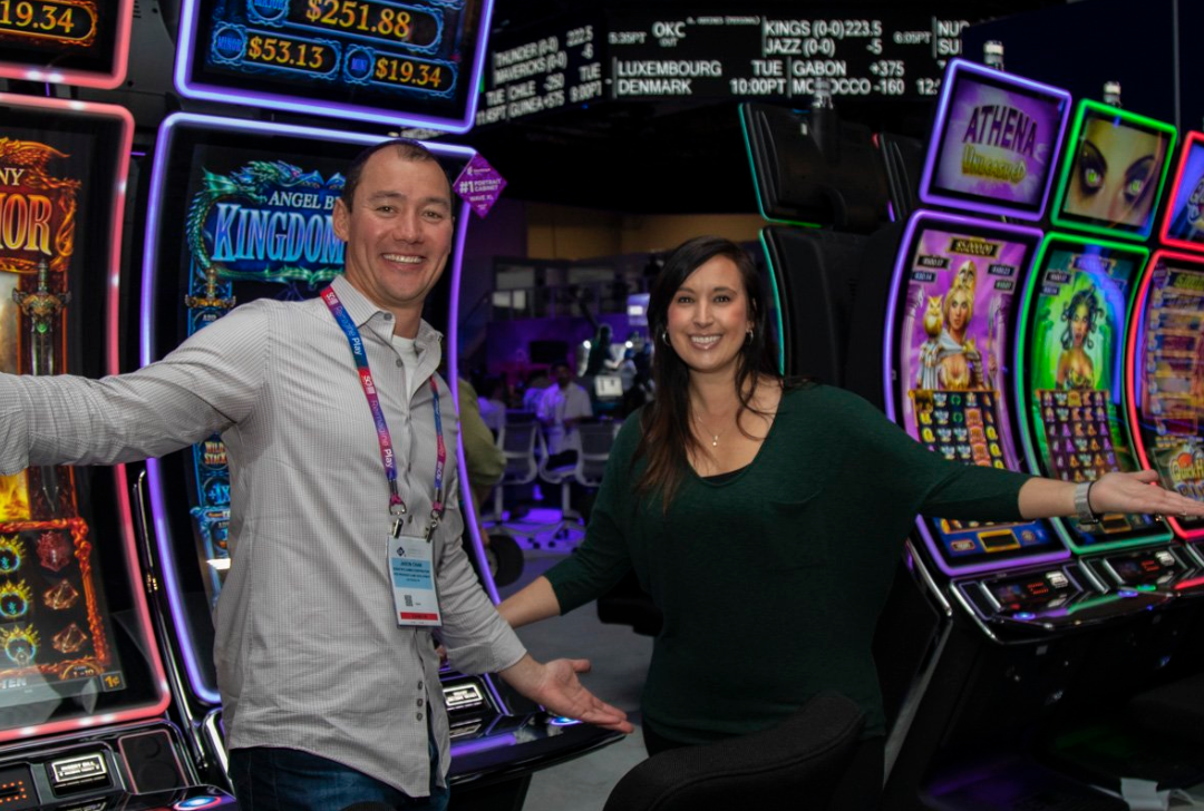 two people infront of gaming machines