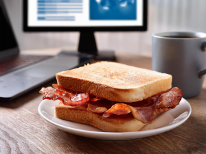 Bacon sandwich on a desk - AI Generated